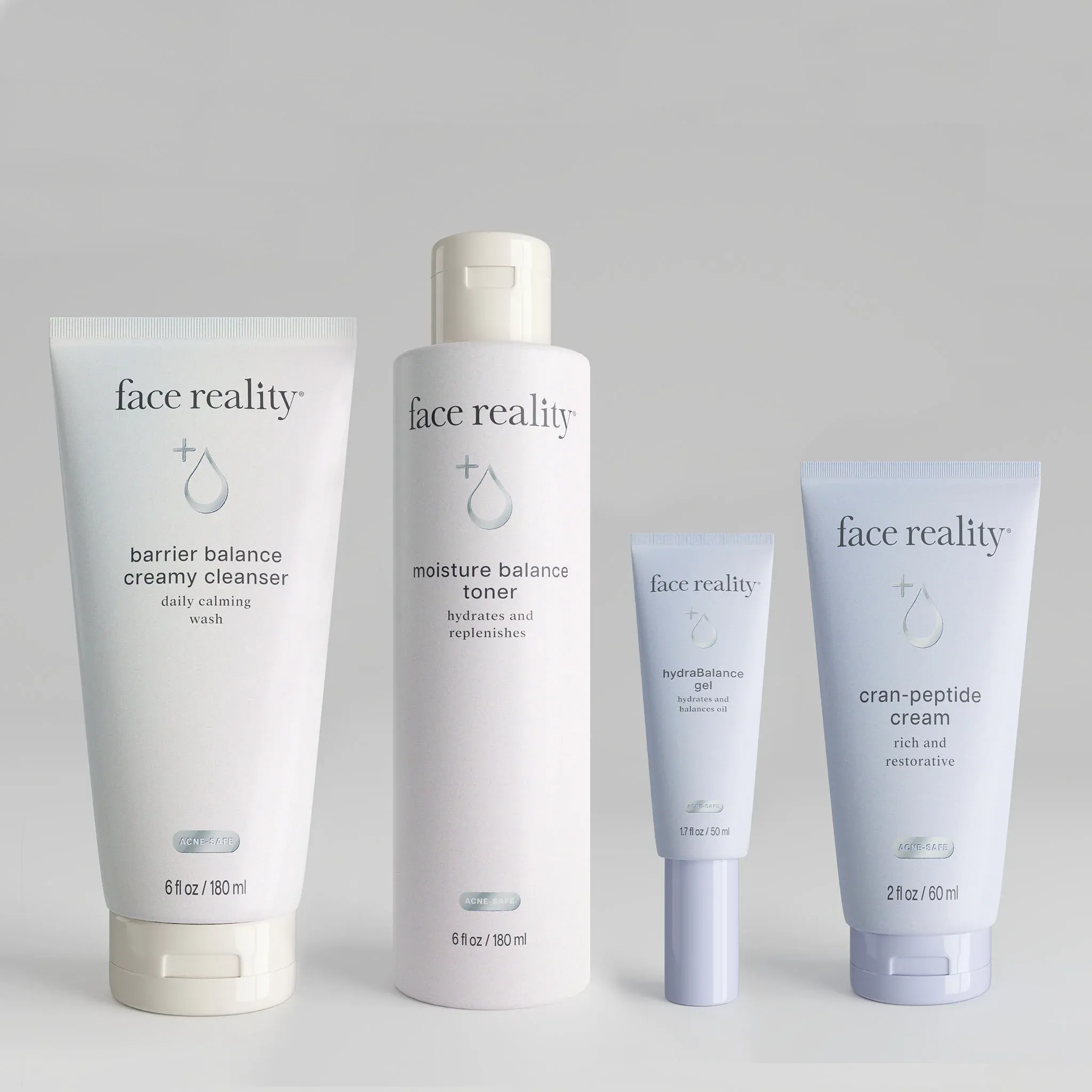 Four light-blue and white skincare tubes and a bottle arranged in a row on a gray background