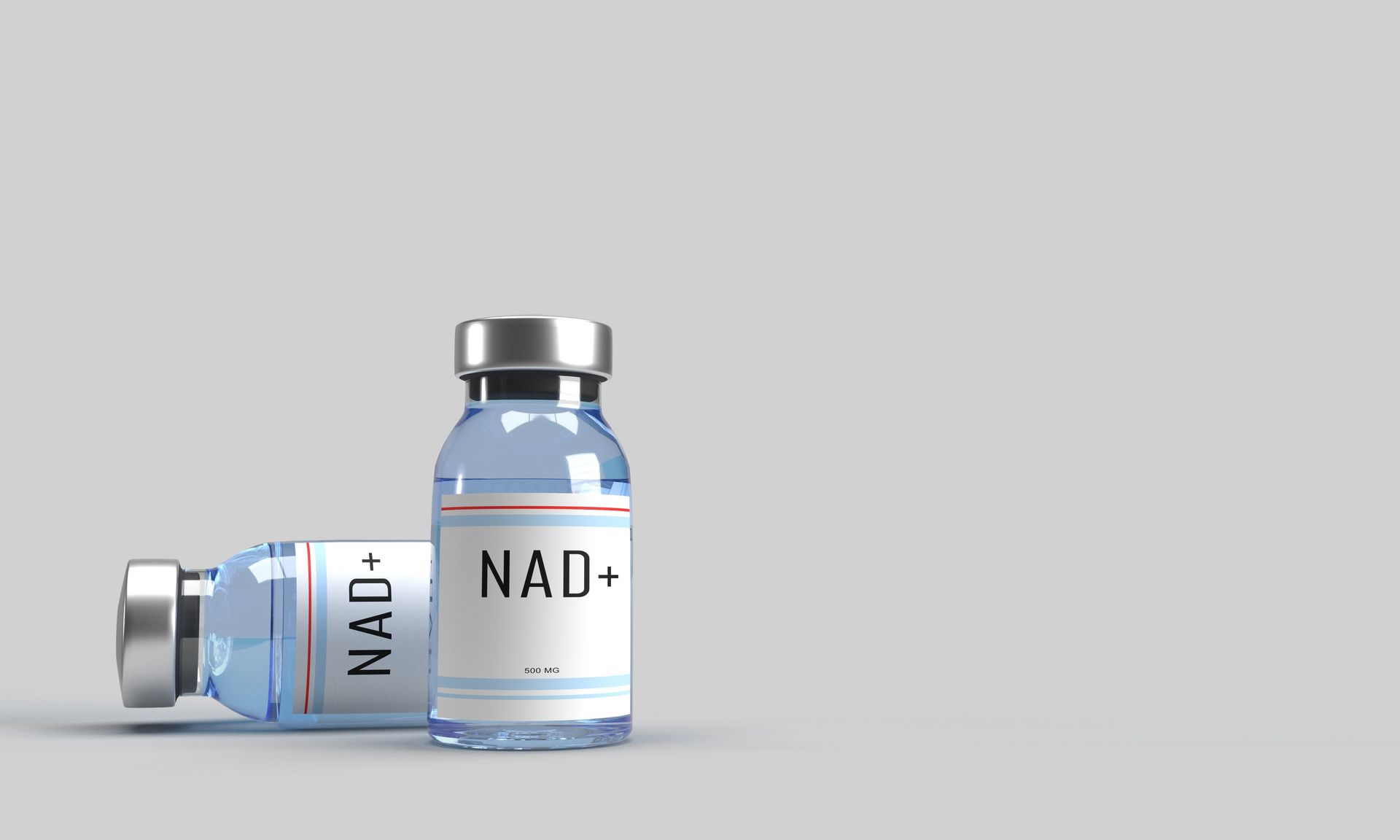 Two blue NAD+ supplement vials with silver caps on a light gray background
